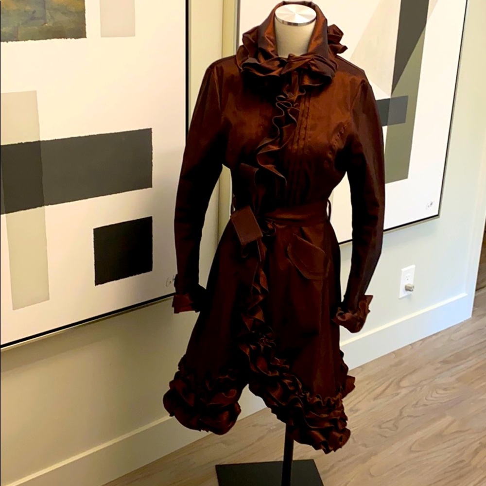 Beautiful ruffle detail raincoat.